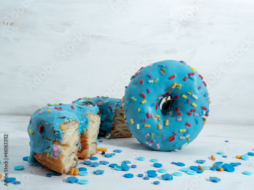 Blue cronuts on a white wooden background. photo