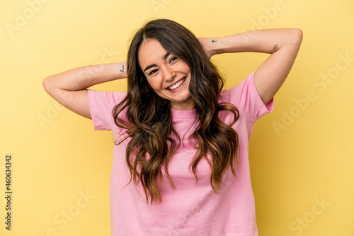Young caucasian woman isolated on yellow background stretching arms, relaxed position.