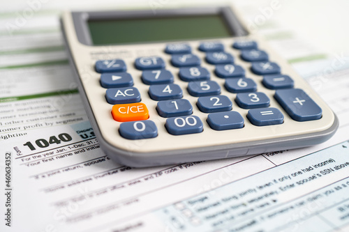 Tax Return form 1040 and dollar banknote, U.S. Individual Income.