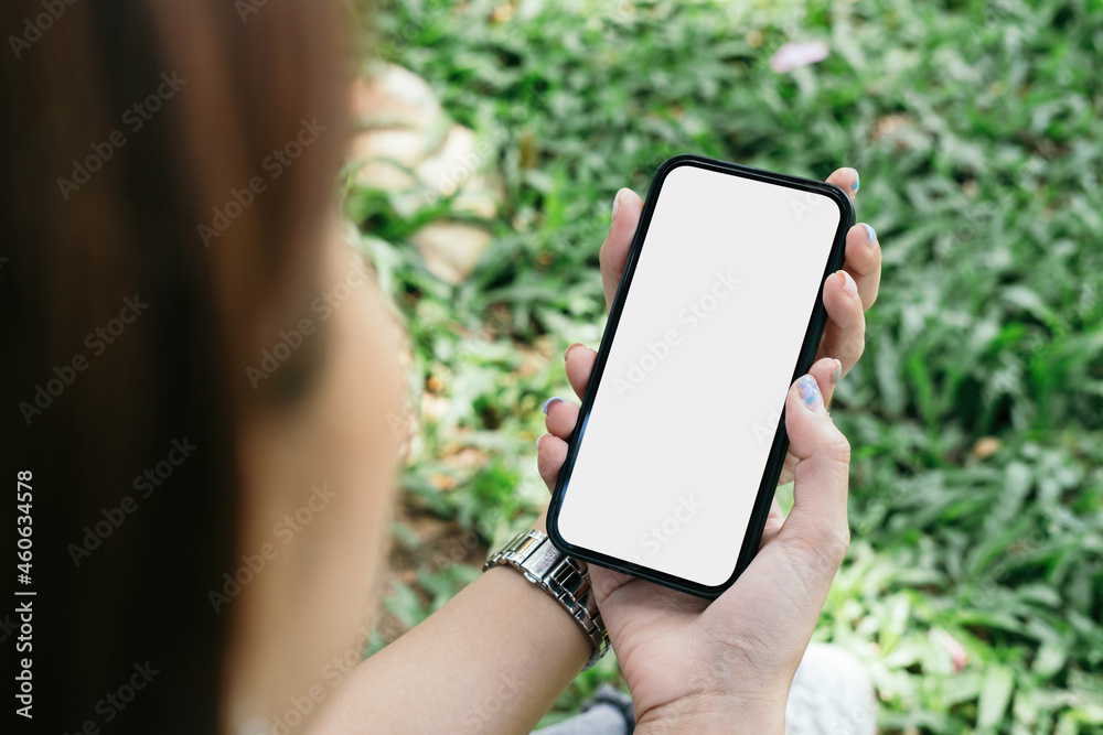mockup image cell phone blank white screen for text. woman hand holding texting message chatting with friend