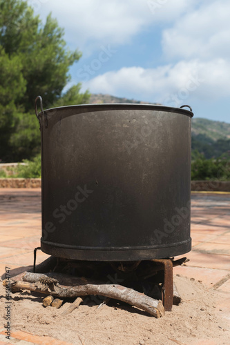 metal cauldron on the fire to make the tomato preserve