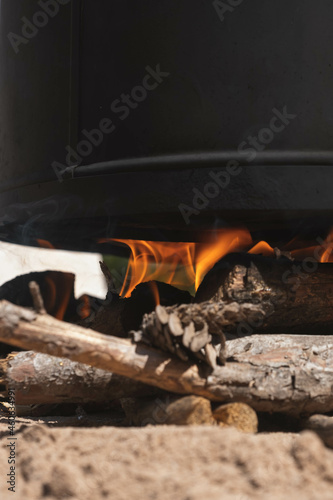 metal cauldron on the fire to make the tomato preserve