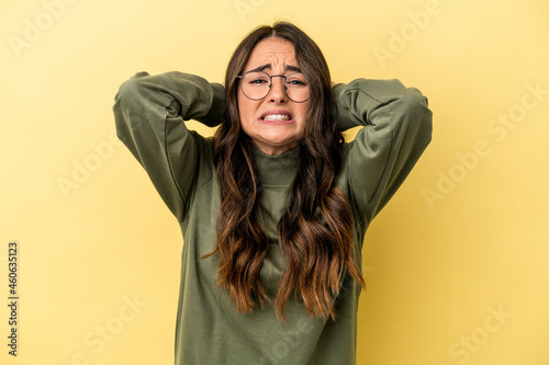 Young caucasian woman isolated on yellow background screaming with rage. © Asier