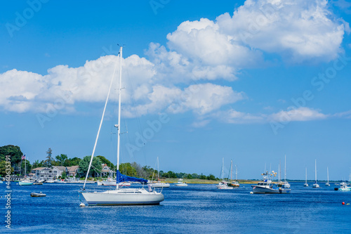 Several yachts and boats docked in the waters of the Merrimack River by the Atlantic Ocean in Newburyport, Massachusetts, USA