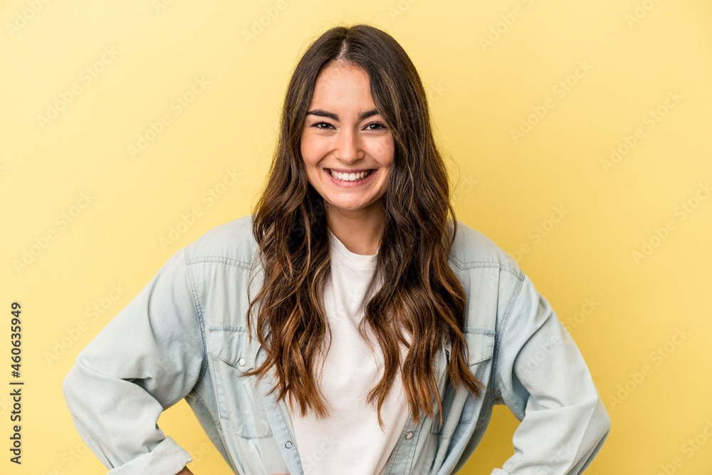 Young caucasian woman isolated on yellow background happy, smiling and cheerful. Young caucasian woman isolated on yellow background happy, smiling and cheerful.