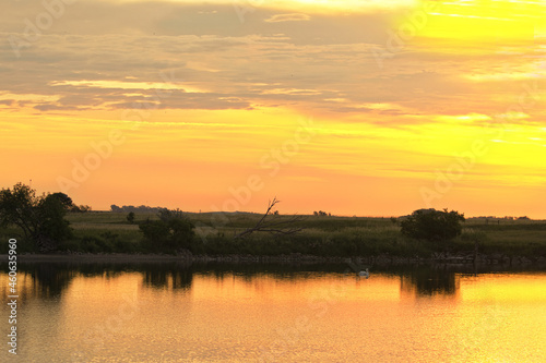 Golden sunrise over Tewaukon National Wildlife Refuge in the North Dakota tall grass prairie wetland ecosystem