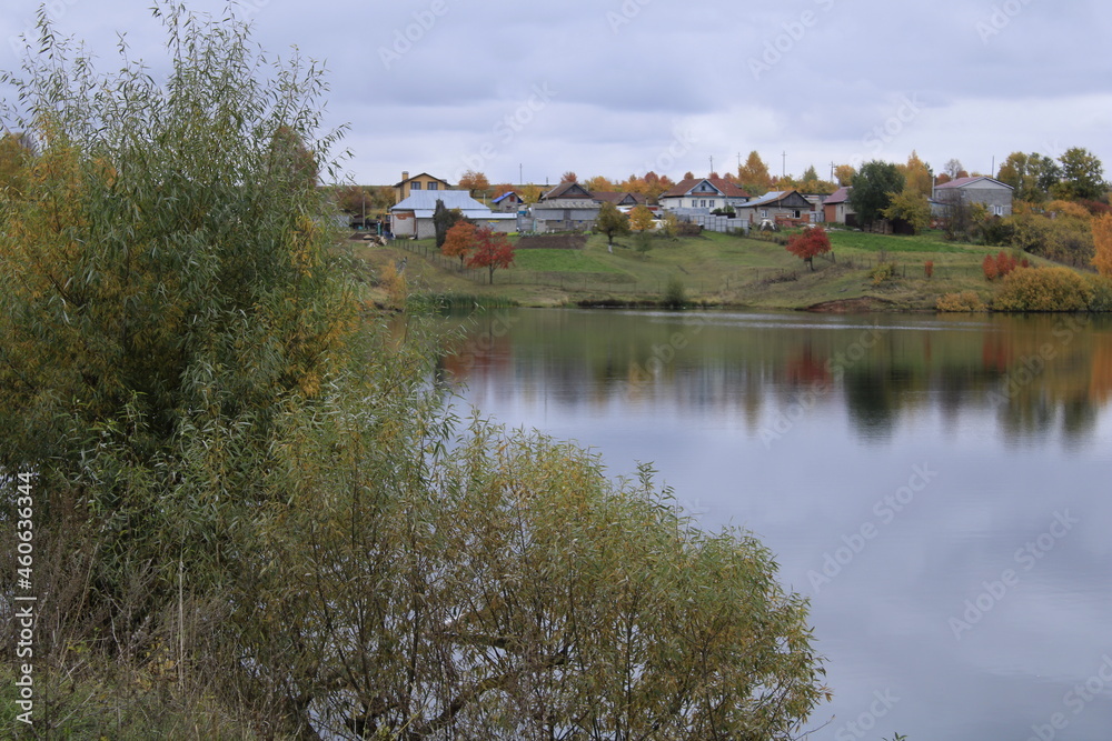 a small lake and an autumn village