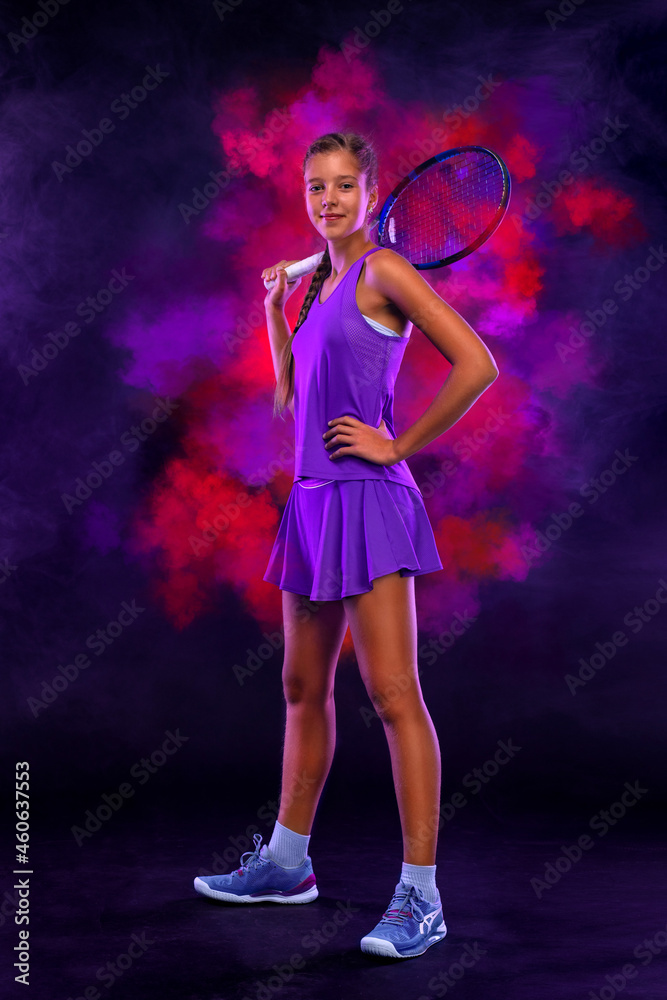 Tennis player. Beautiful girl teenager and athlete with racket in pink sporswear and hat on tennis court. Sport concept.