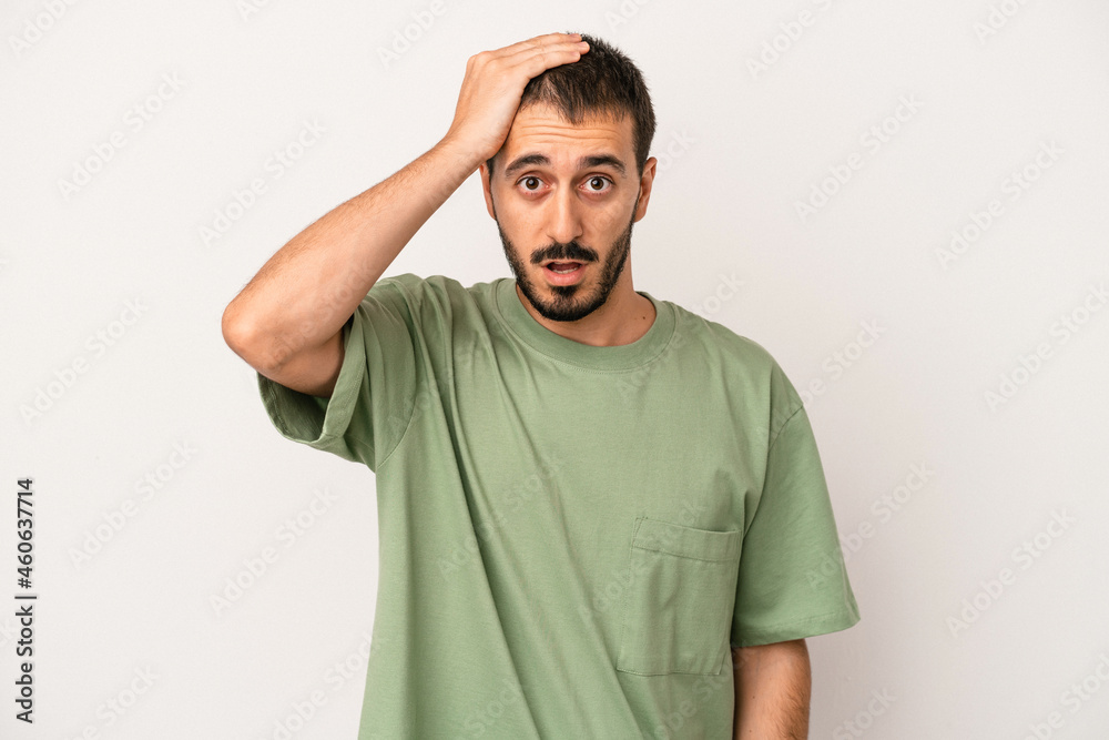Fototapeta premium Young caucasian man isolated on white background being shocked, she has remembered important meeting.