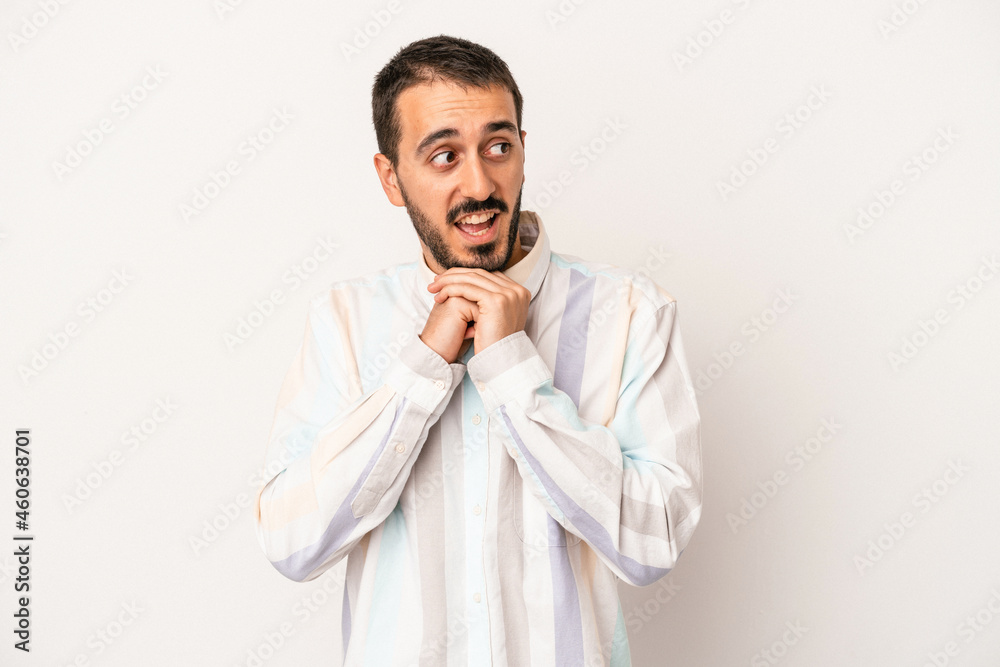 Young caucasian man isolated on white background praying for luck, amazed and opening mouth looking to front. Young caucasian man isolated on white background praying for luck, amazed and opening mouth looking to front.