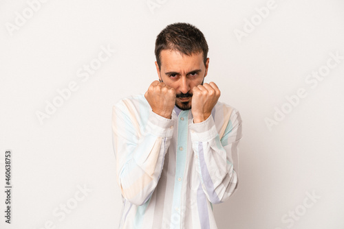 Young caucasian man isolated on white background throwing a punch, anger, fighting due to an argument, boxing.