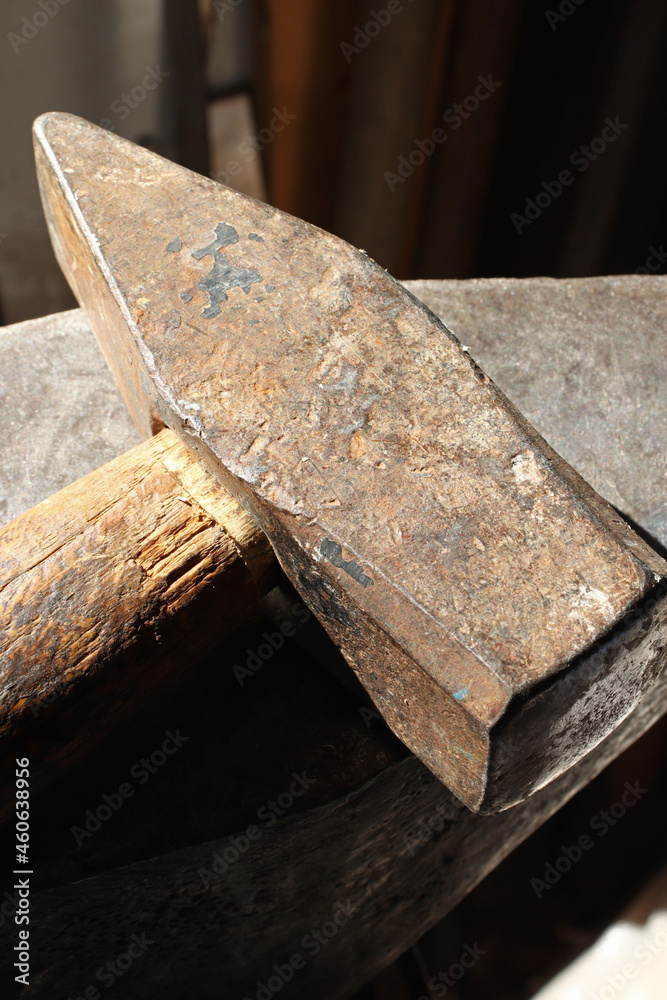 close-up old hammer in blacksmith workshop