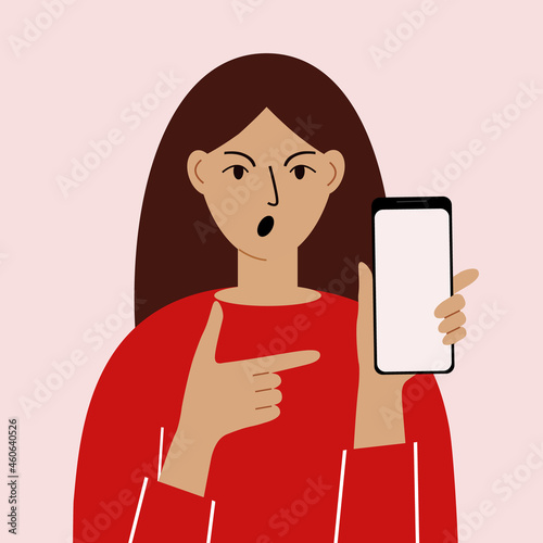 Angry woman with mobile phone, front view. Indicates the phone. News. Smartphone and internet addiction.