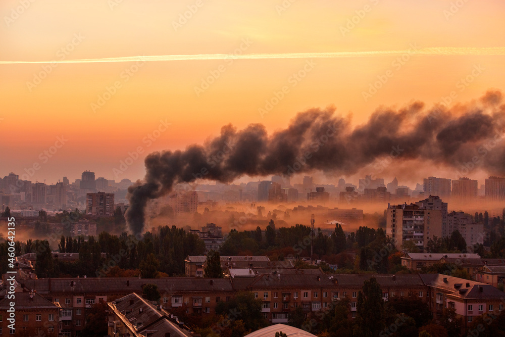 Early morning cityscape with black smoke from the conflagration.