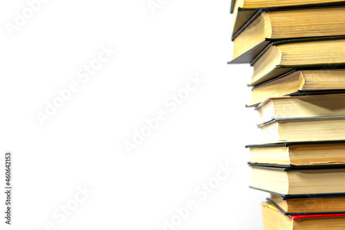 Stack of books on a white background. The books are on top of each other close-up.
