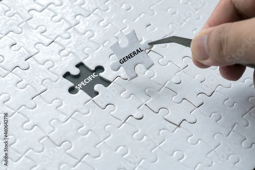 A hand pick a piece of jigsaw puzzle written with General and an empty space of jigsaw puzzle written with Specific.