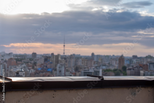 Close up. Parapet in sharpness. Business center of Kiev in blur on the background. © Maryna