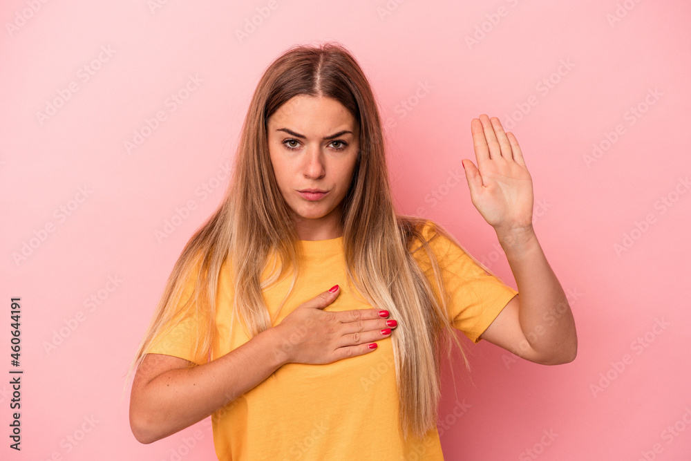 Young Russian woman isolated on pink background covering ears with fingers, stressed and desperate by a loudly ambient. Young Russian woman isolated on pink background covering ears with fingers, stressed and desperate by a loudly ambient.