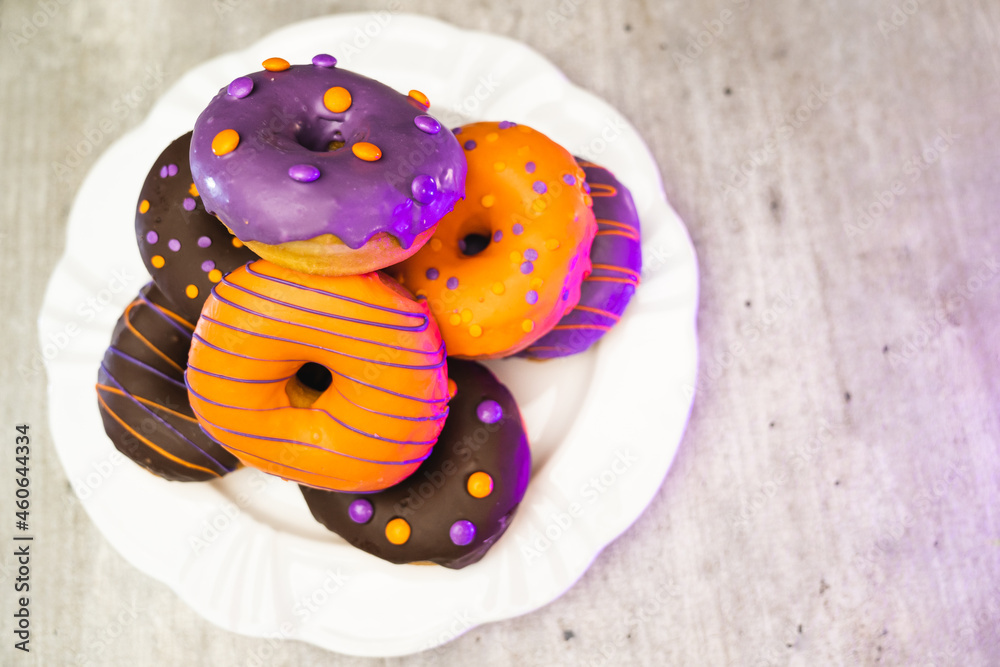 halloween donut on the plate with light wooden texture background