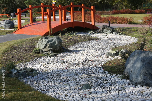 Little Japan in Kurkino district, Moscow city, Russia. Japanese garden. Japanese autumn park in Moscow with stones and plants. Architecture in asian, japanese style. Red bridge in Japanese garden photo