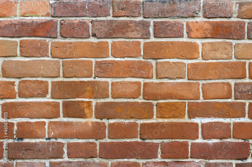 Red brick wall texture with cracks and scratches for background