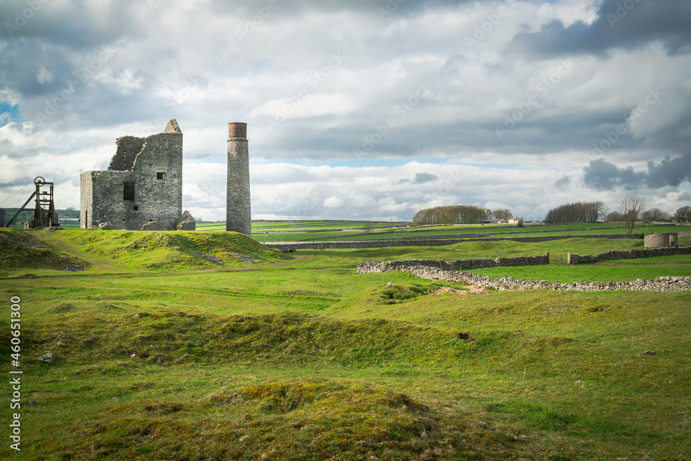 The Cornish engine house, circular chimney, pit-head gear and powder house at Magpie Mine, Sheldon, a preserved lead mine in the Peak District National Park
