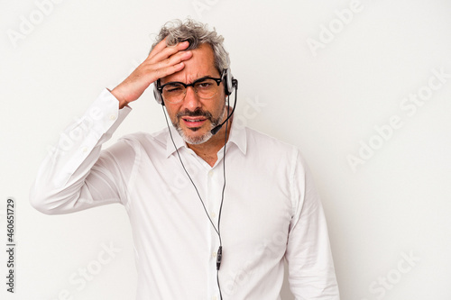 Middle age telemarketer caucasian man isolated on white background being shocked, she has remembered important meeting.