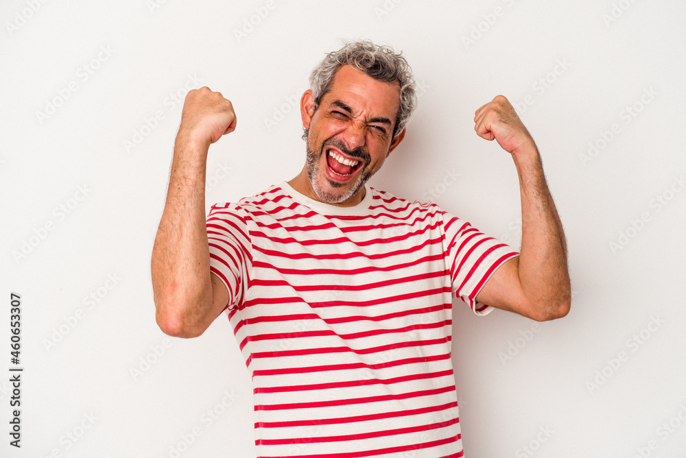 Middle age caucasian man isolated on white background  raising fist after a victory, winner concept.