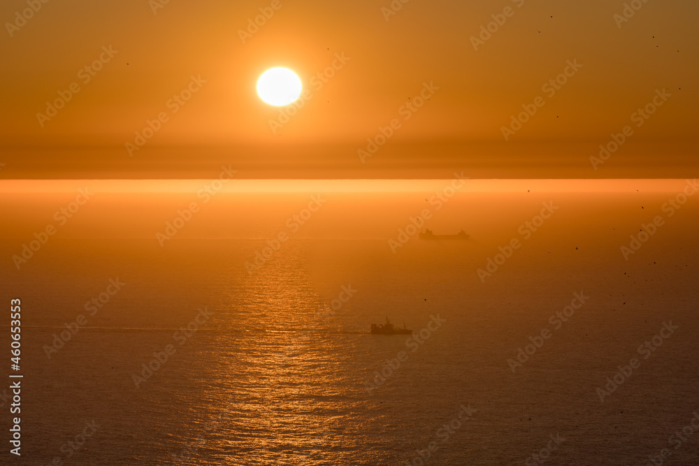 Boat`s passing by sunset at bird Island Runde.