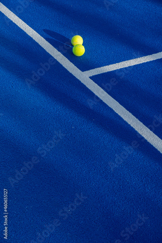 Two balls next to the lines of a paddle tennis court © Vic
