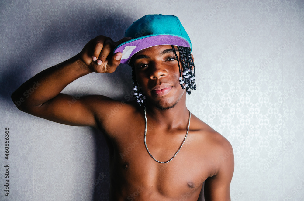 young dark-skinned man of Dominican Latino origin with braids in his ...