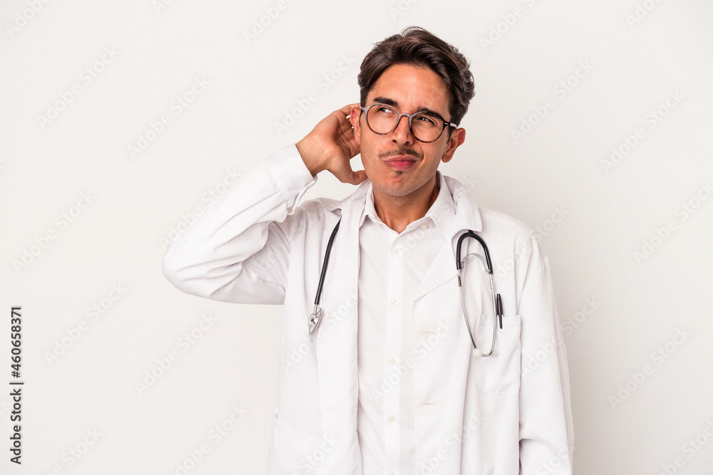 Young mixed race doctor man isolated on white background touching back of head, thinking and making a choice. Young mixed race doctor man isolated on white background touching back of head, thinking and making a choice.