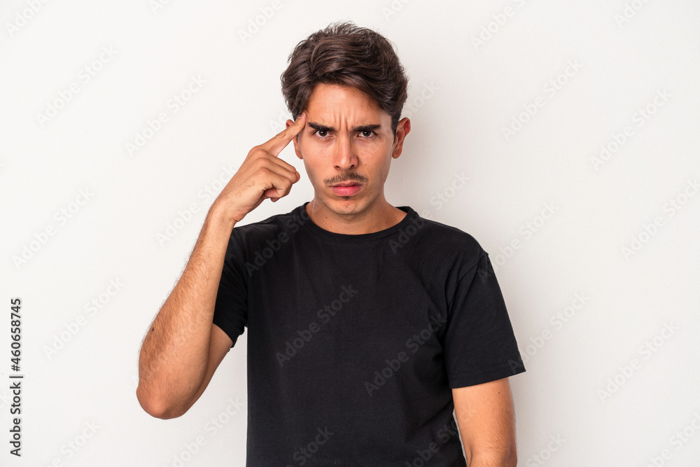 Young mixed race man isolated on white background pointing temple with finger, thinking, focused on a task. Young mixed race man isolated on white background pointing temple with finger, thinking, focused on a task.