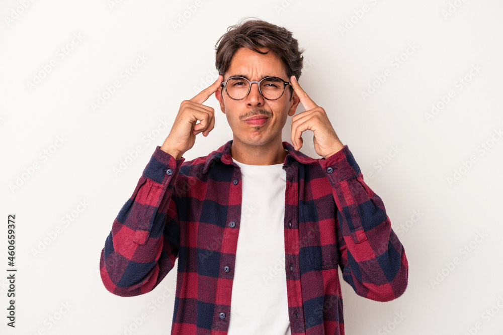 Young mixed race man isolated on white background focused on a task, keeping forefingers pointing head. Young mixed race man isolated on white background focused on a task, keeping forefingers pointing head.
