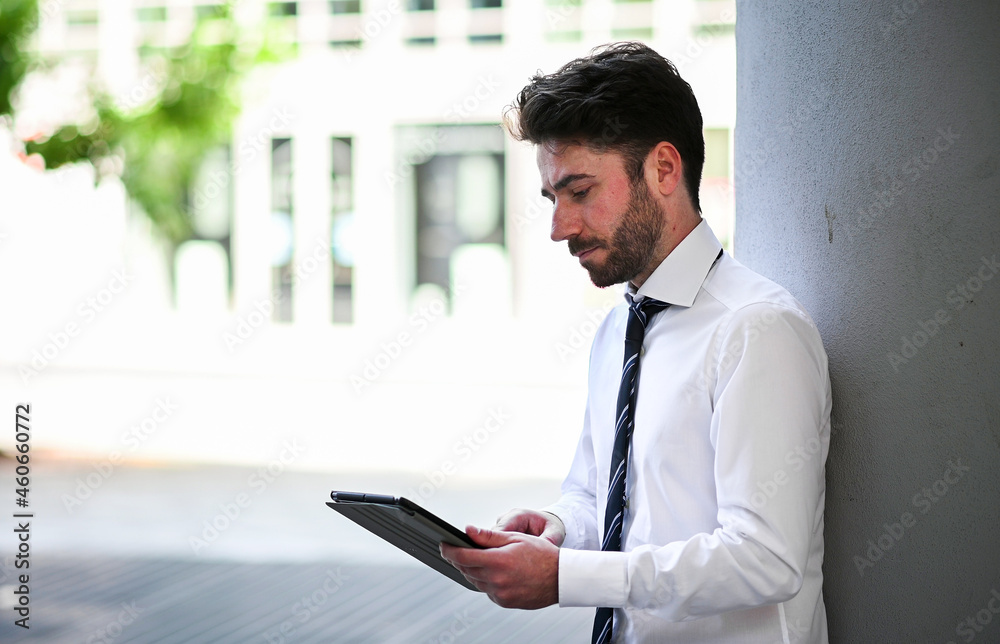 Fototapeta premium Young manager using a digital tablet outdoor