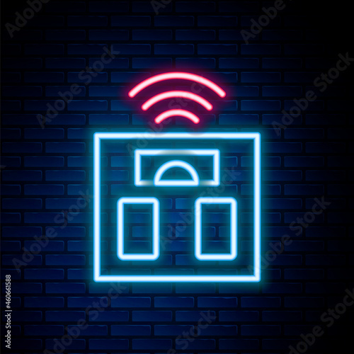 Glowing neon line Smart bathroom scales icon isolated on brick wall background. Weight measure equipment. Internet of things concept with wireless connection. Colorful outline concept. Vector