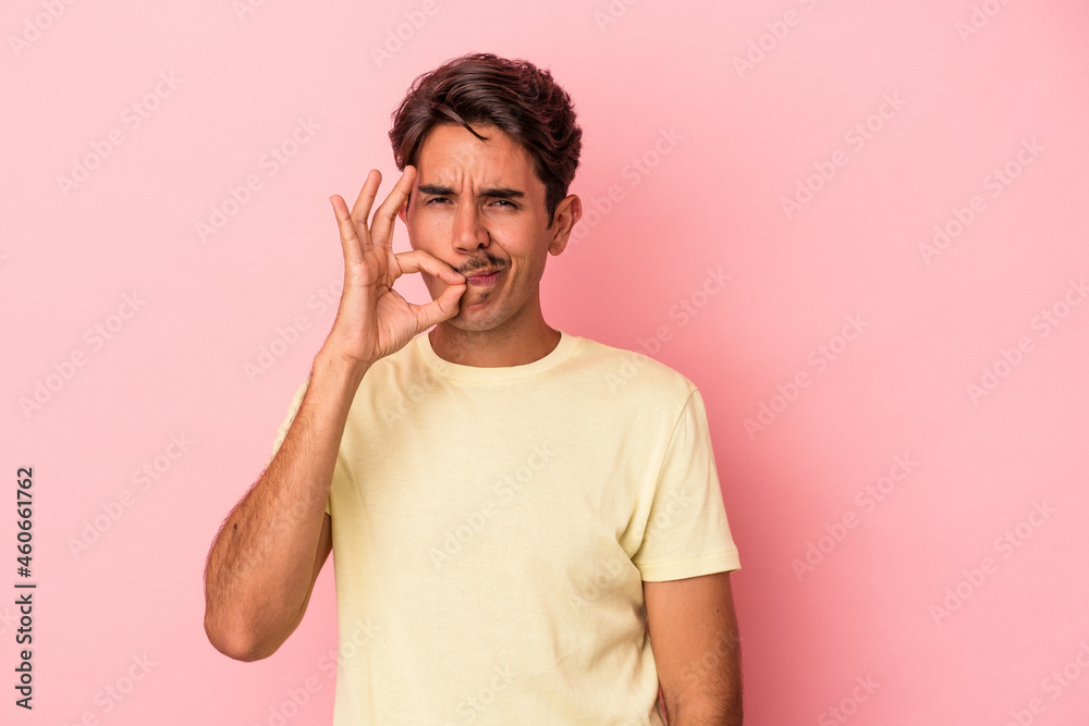 Young mixed race man isolated on white background with fingers on lips keeping a secret. Young mixed race man isolated on white background with fingers on lips keeping a secret.