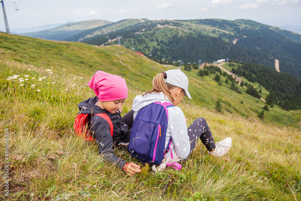 Little girls hiker relaxing on the peak, beautiful view on nature landscape