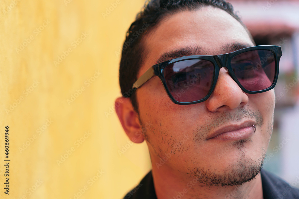 Portrait of handsome latin hipster man looking at camera. Lifestyle concept Portrait of handsome latin hipster man looking at camera. Lifestyle concept