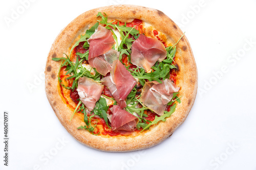 Traditional pizza with ham and arugula.