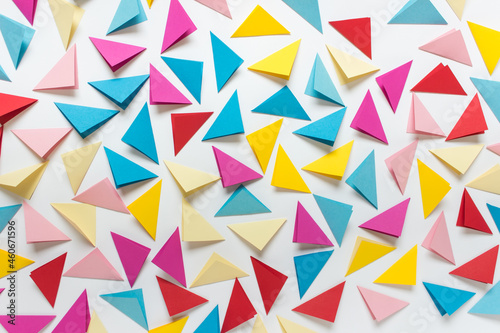 Abstract background with randomly arranged colorful folded triangles on white background