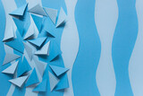 Paper background with many blue folder triangles and blue paper layers