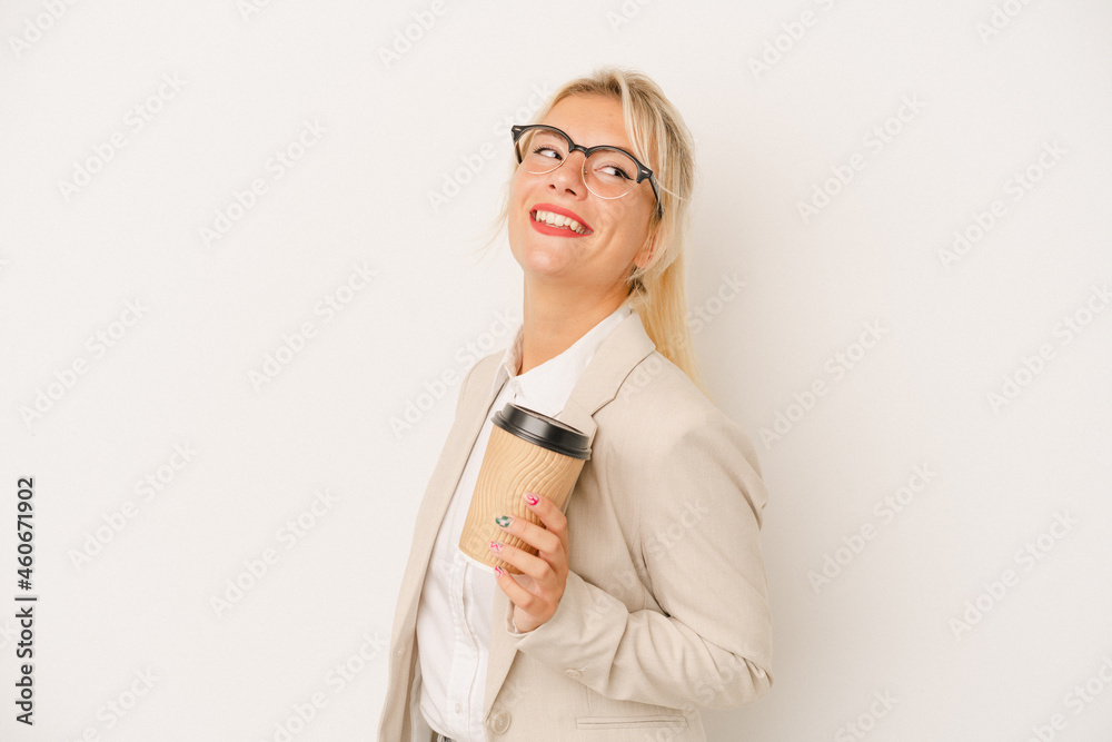 Young business Russian woman holding take away coffee isolated on white background looks aside smiling, cheerful and pleasant.