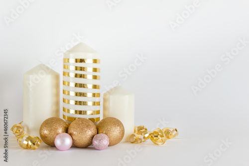 Christmas, New Year composition with white candles, golden and pink baubles, balls on white backgound photo