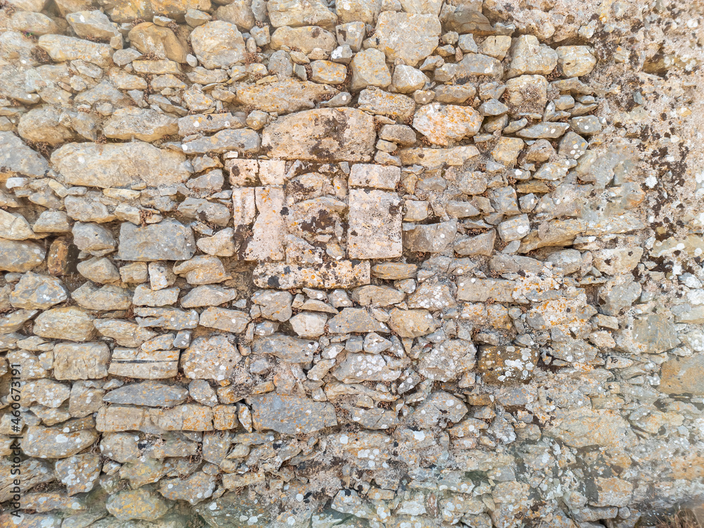 Old weathered exterior rough strong stone wall Old weathered exterior rough strong stone wall