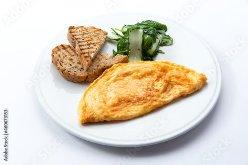 Omelet and toast on a plate. Isolated on white.