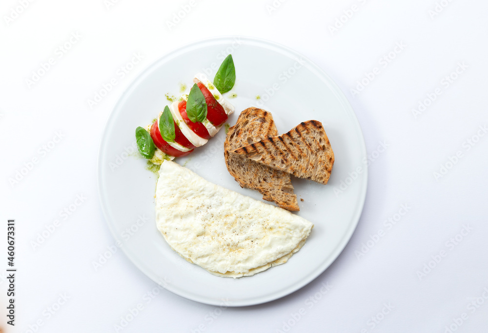 Omelet and toast on a plate. Isolated on white. Omelet and toast on a plate. Isolated on white.