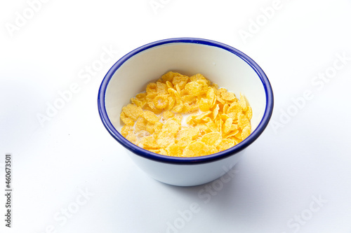 Breakfast cereals. With milk. In a plate. Isolated on white.