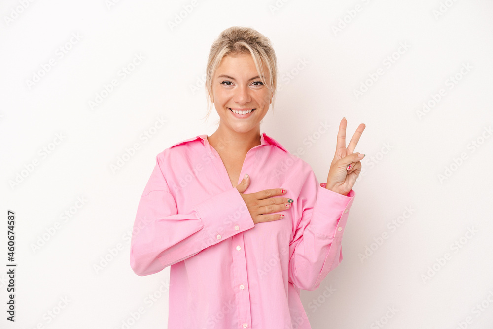 Young Russian woman isolated on white background taking an oath, putting hand on chest. Young Russian woman isolated on white background taking an oath, putting hand on chest.