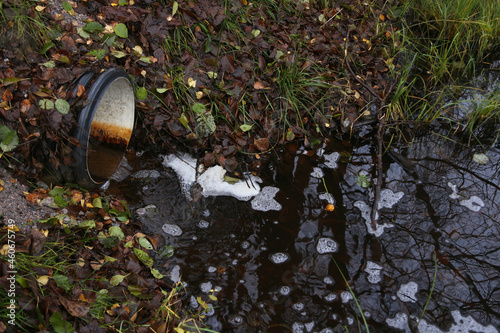 Drain introduces dirty water into lake, horizontal picture